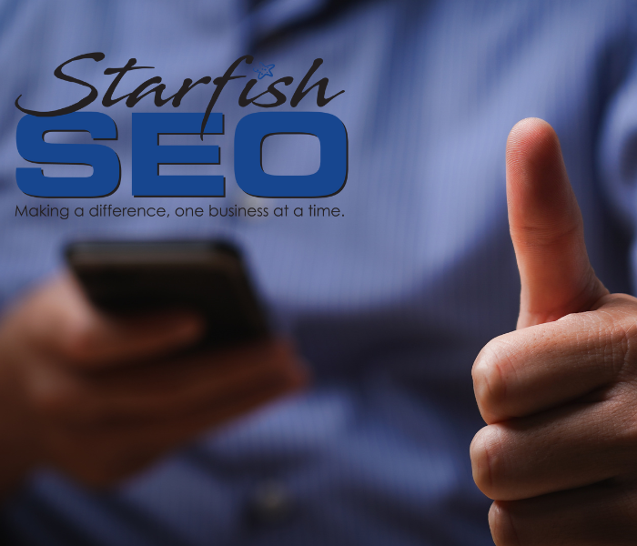 A person gives the thumbs up sign while reading a positive online review.